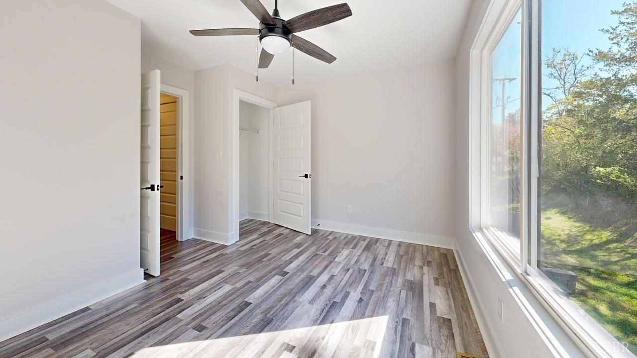128 Allure Drive Rustburg, VA 24588 - Photo 30 of 30 an empty room with wooden floor fan and windows