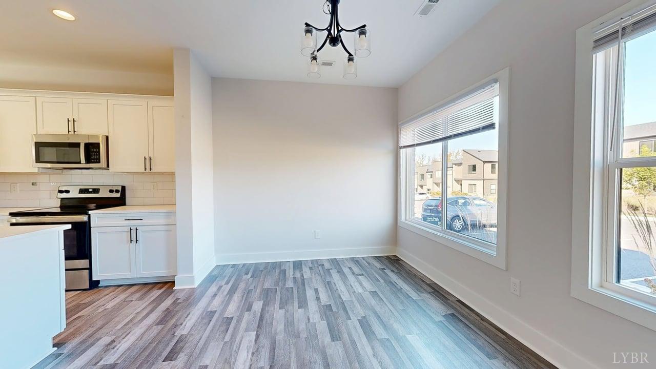 128 Allure Drive Rustburg, VA 24588 - Photo 4 of 30 a kitchen with wooden floors and stainless steel appliances