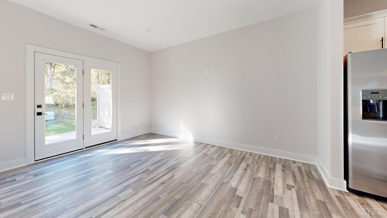 128 Allure Drive Rustburg, VA 24588 - Photo 9 of 30 a view of an empty room with wooden floor and a window