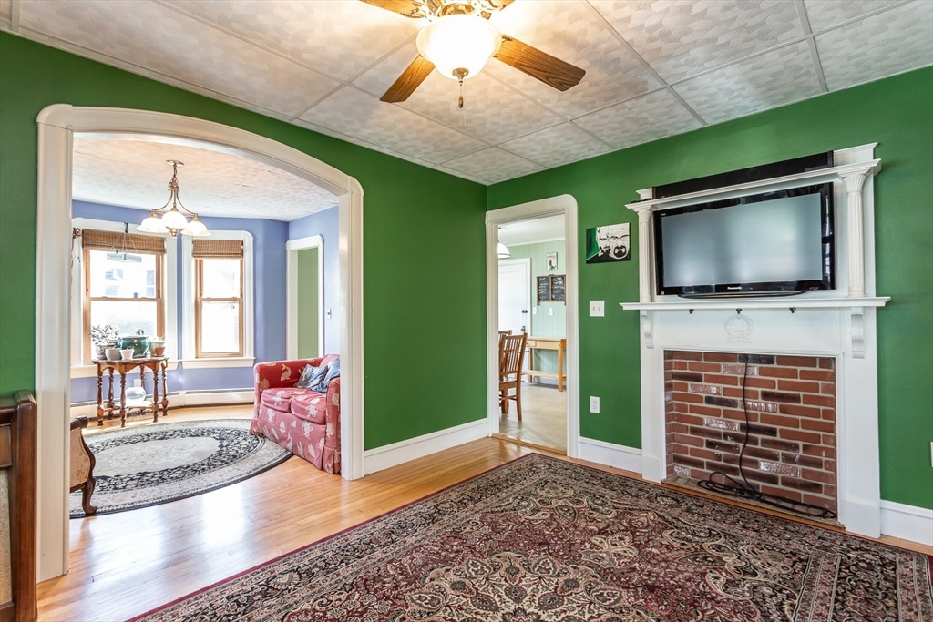 123 Huard Street Fall River, MA 02721 - Photo 11 of 26 a living room with fireplace furniture and a flat screen tv