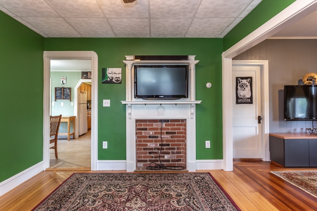 123 Huard Street Fall River, MA 02721 - Photo 13 of 26 a living room with fireplace and a flat screen tv