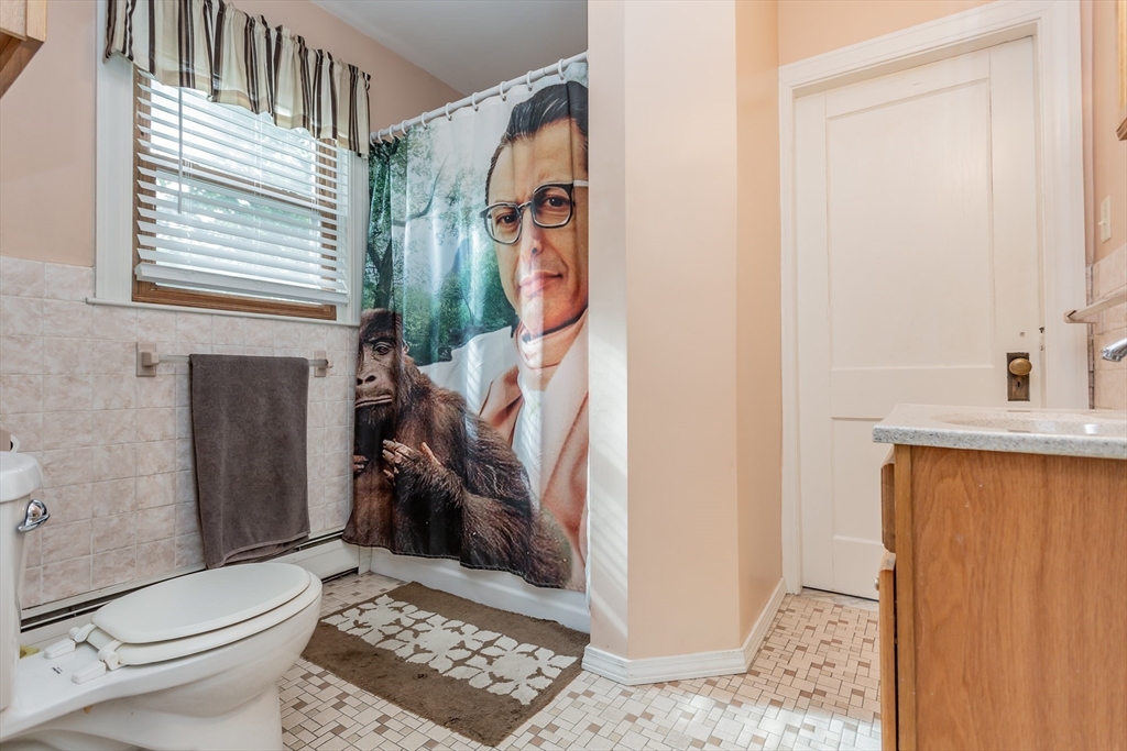 123 Huard Street Fall River, MA 02721 - Photo 16 of 26 a bathroom with a toilet a sink and a mirror