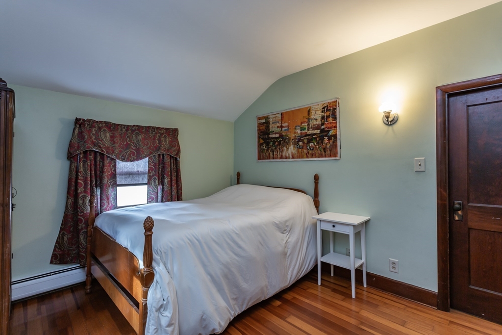 123 Huard Street Fall River, MA 02721 - Photo 22 of 26 a bedroom with a bed a dresser and wooden floor