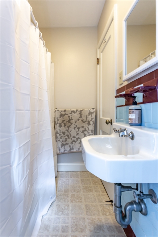 123 Huard Street Fall River, MA 02721 - Photo 23 of 26 a bathroom with a sink a toilet and mirror