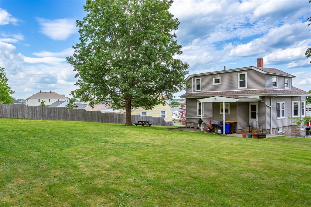 123 Huard Street Fall River, MA 02721 - Photo 25 of 26 a view of a big house with a big yard and large trees