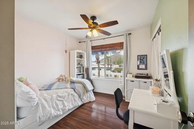 a bedroom with furniture and a large window