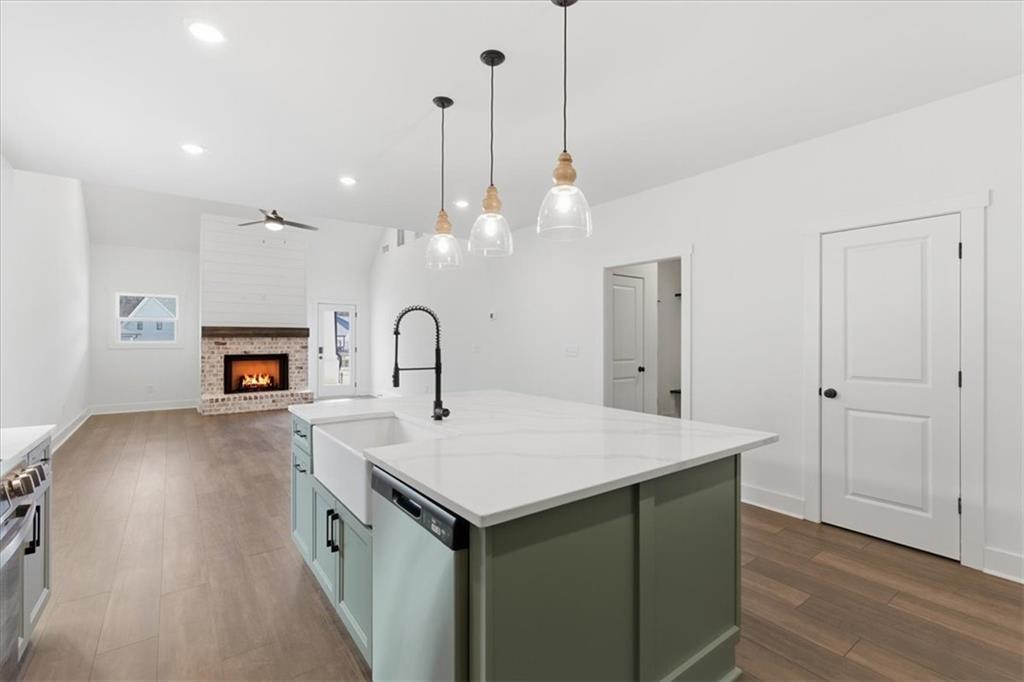 135 Old Alabama Road Southeast Emerson, GA 30137 - Photo 24 of 57 a kitchen with a sink a chandelier and wooden floor