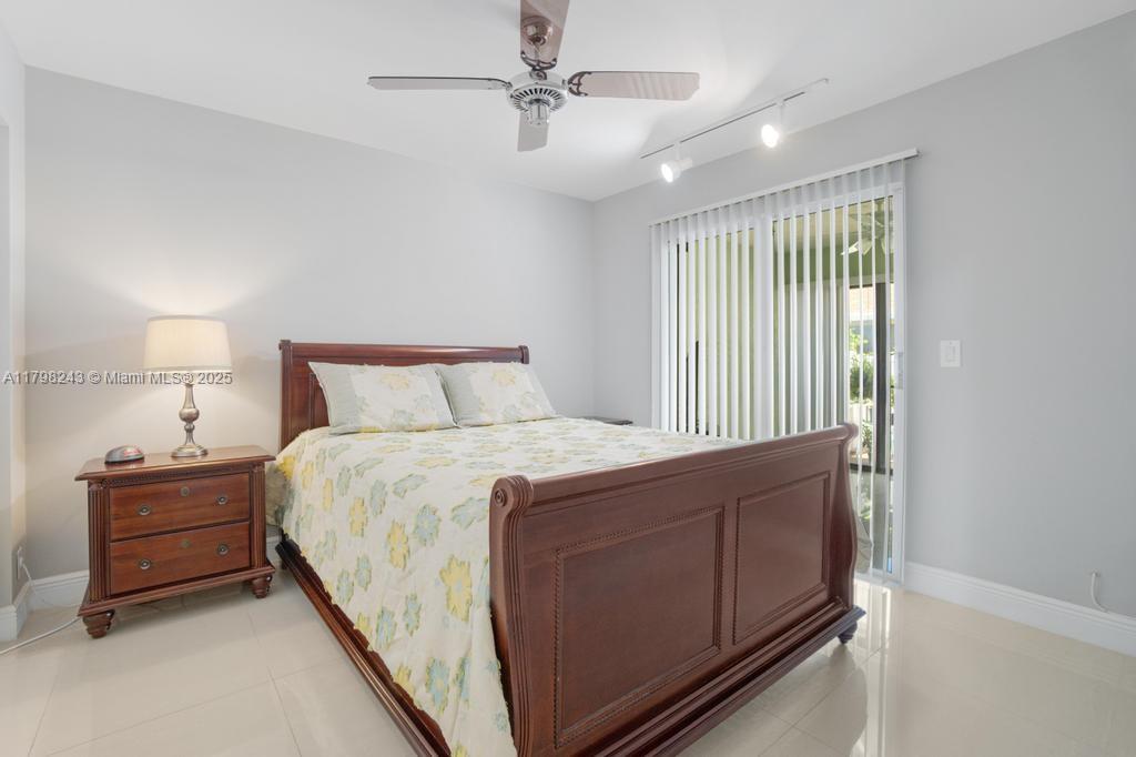 8080 Sweetbriar Way Boca Raton, FL 33496 - Photo 17 of 30 a bedroom with a bed and a window