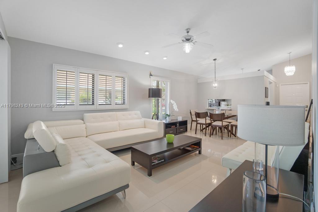 8080 Sweetbriar Way Boca Raton, FL 33496 - Photo 8 of 30 a living room with furniture kitchen view and a large window