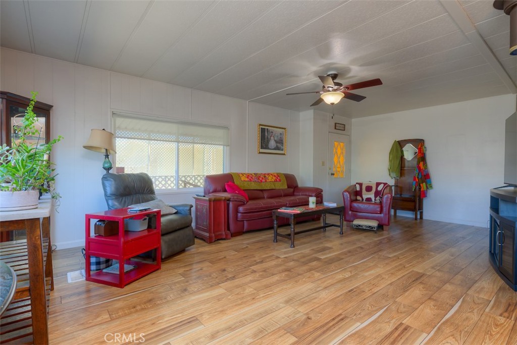 1901 Dayton Road, Unit 133 Chico, CA 95928 - Photo 8 of 36 a living room with furniture gym equipment and a chandelier
