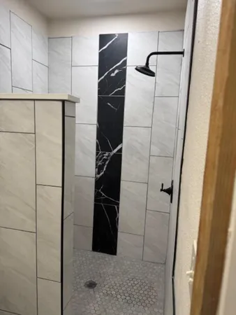 a utility room with sink and mirror