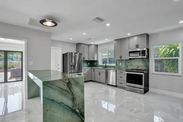 a kitchen with refrigerator a oven and cabinets