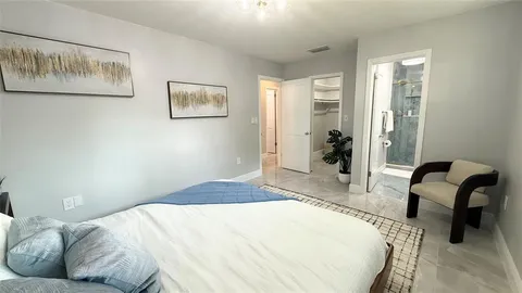 a bedroom with a bed and a chair