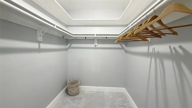 a view of walk in closet with clothes