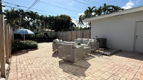 a view of a patio with a table and chairs and potted plants