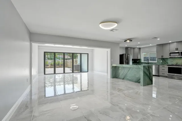 a view of a kitchen with furniture and a large window