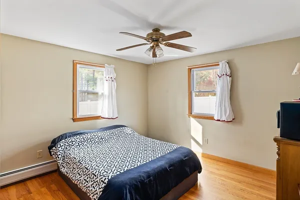 a bedroom with a bed and a window