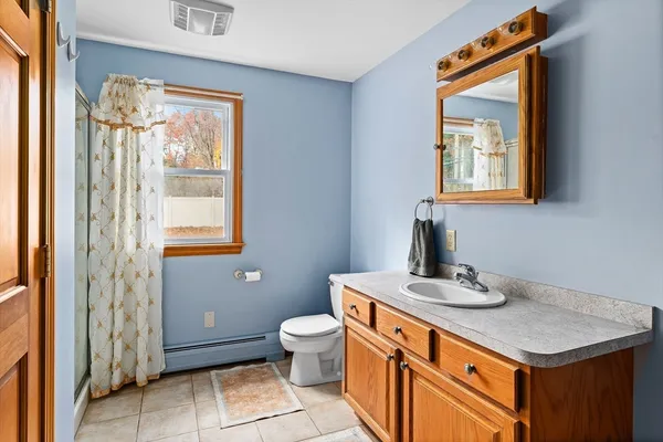 a bathroom with a sink a toilet and a mirror