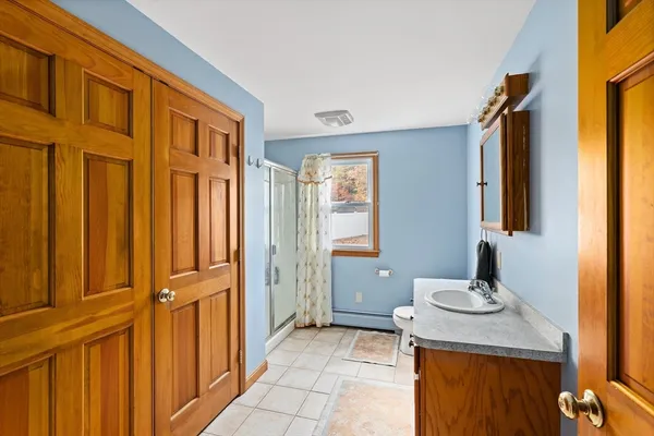 a bathroom with a granite countertop sink and a mirror