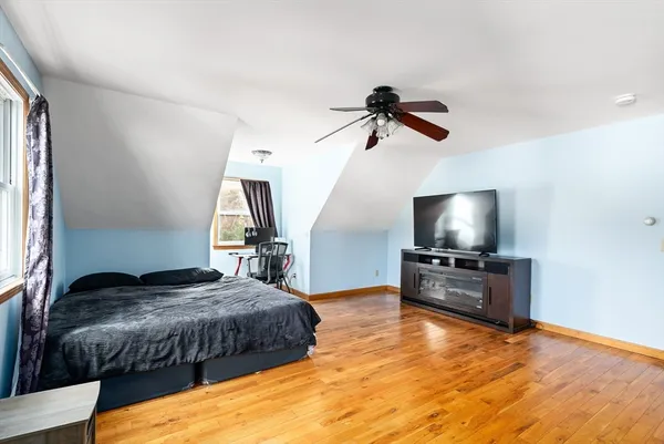 a bedroom with a bed and a flat screen tv