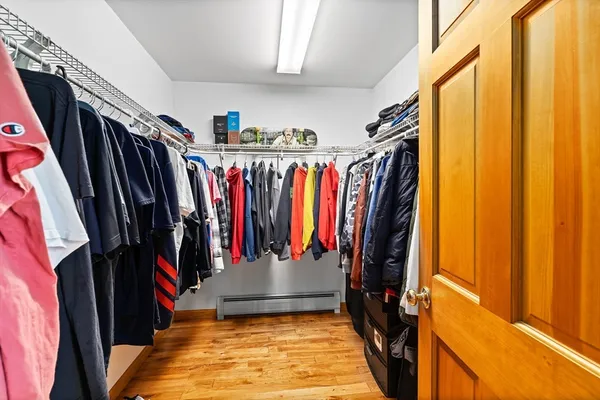 a view of walk in closet with clothes