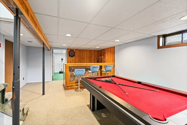 a room with wooden furniture and pool table