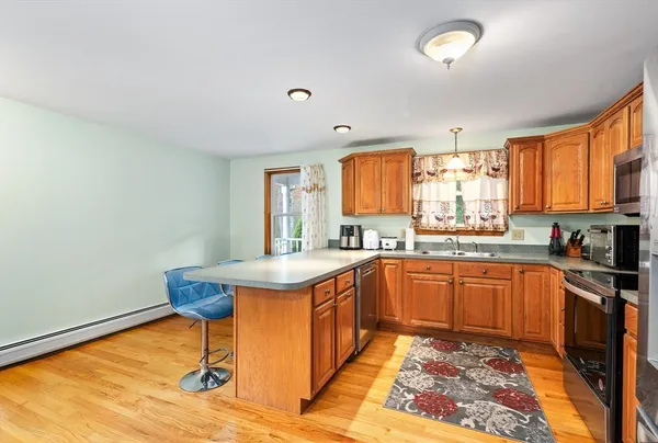 a kitchen with stainless steel appliances granite countertop a sink stove and window