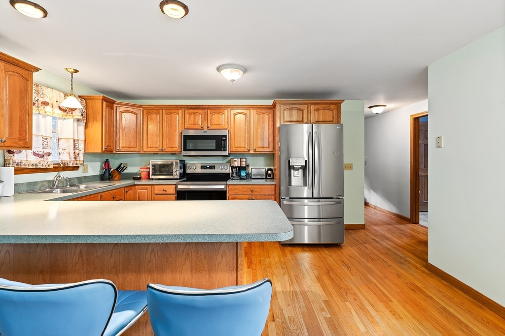 1 Plain Street Easthampton, MA 01027 - Photo 8 of 41 a kitchen with stainless steel appliances a refrigerator and a stove top oven