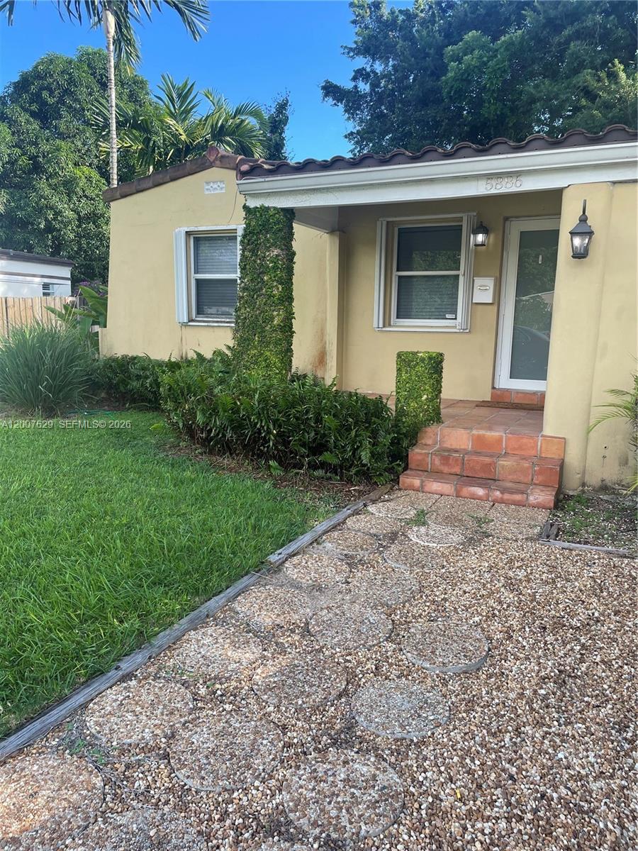 5886 Southwest 42nd Street Miami, FL 33155 - Photo 18 of 20 a front view of a house with garden