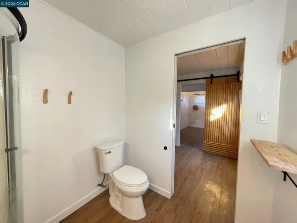 a bathroom with a granite countertop sink mirror vanity and toilet