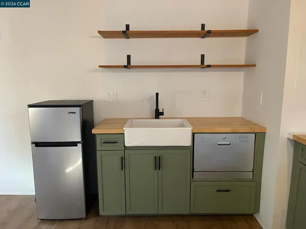 a kitchen with a sink and a refrigerator
