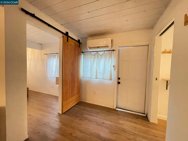 a view of a storage & utility room with wooden floor