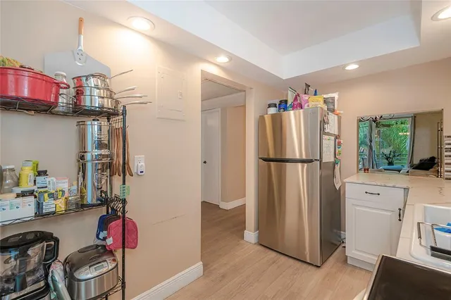 a kitchen with stainless steel appliances granite countertop a refrigerator and a stove