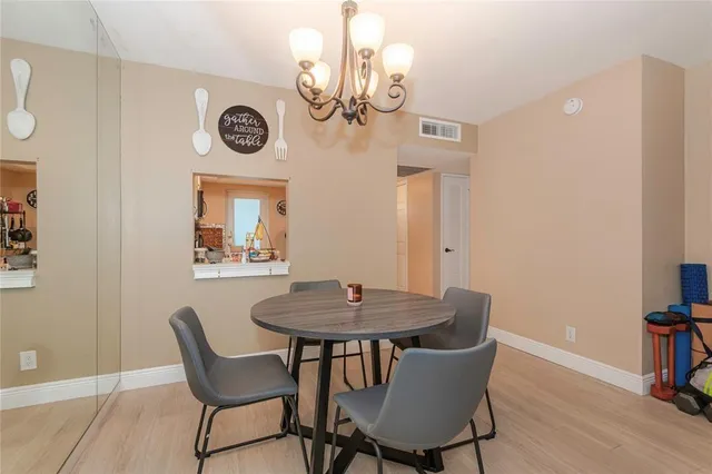 a dining room with furniture and wooden floor
