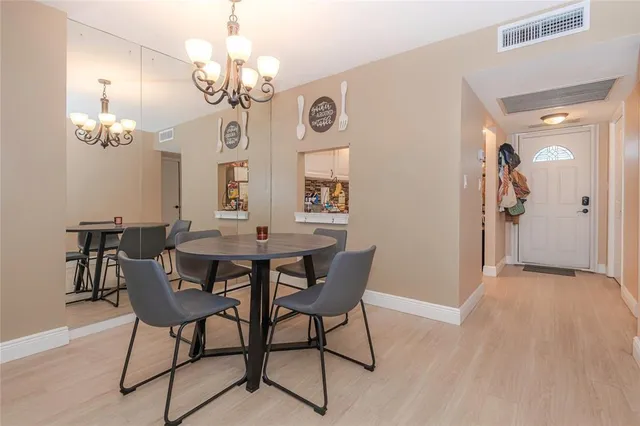 a view of a dining room with furniture and chandelier