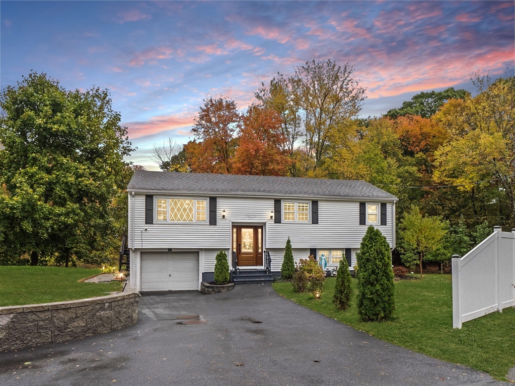 a view of a house with a yard and tree s