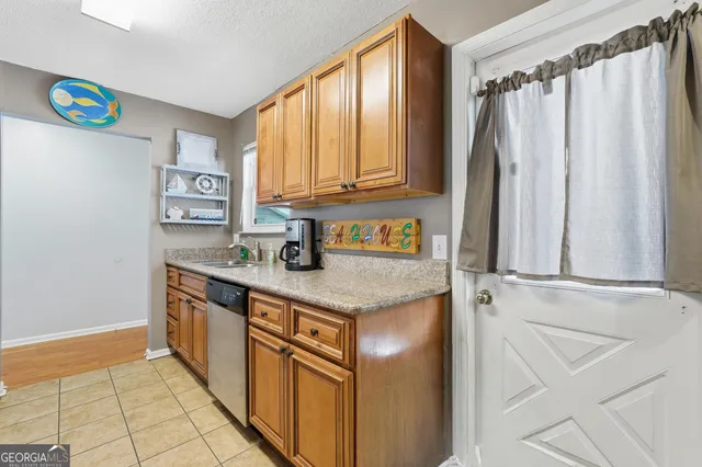 a kitchen with stainless steel appliances granite countertop a sink and cabinets