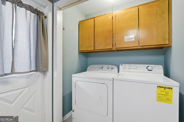 a dining room with furniture a chandelier and wooden floor