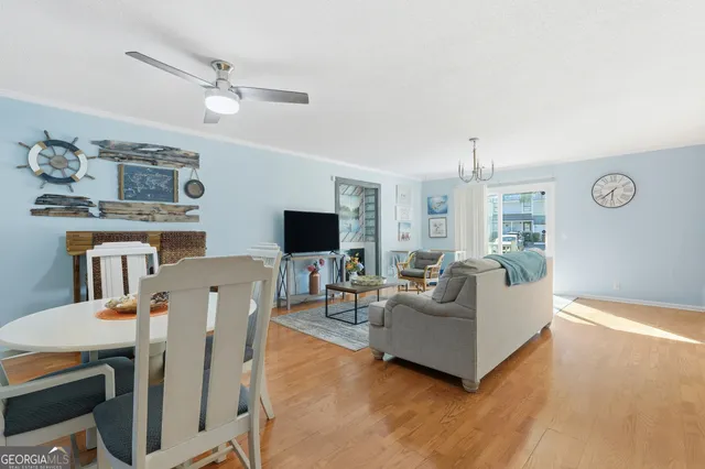 a living room with furniture a dining table and a window
