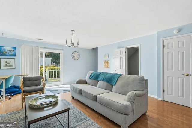 a living room with furniture and a floor to ceiling window