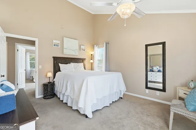 a bedroom with a bed and a painting on the wall