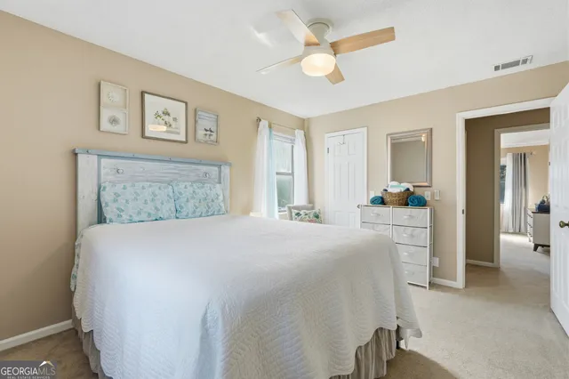 a view of a chair and table in backyard of the house