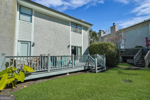 an aerial view of a house with a yard and large trees