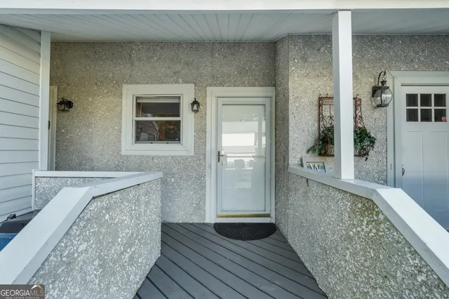 a view of hallway with wooden floor