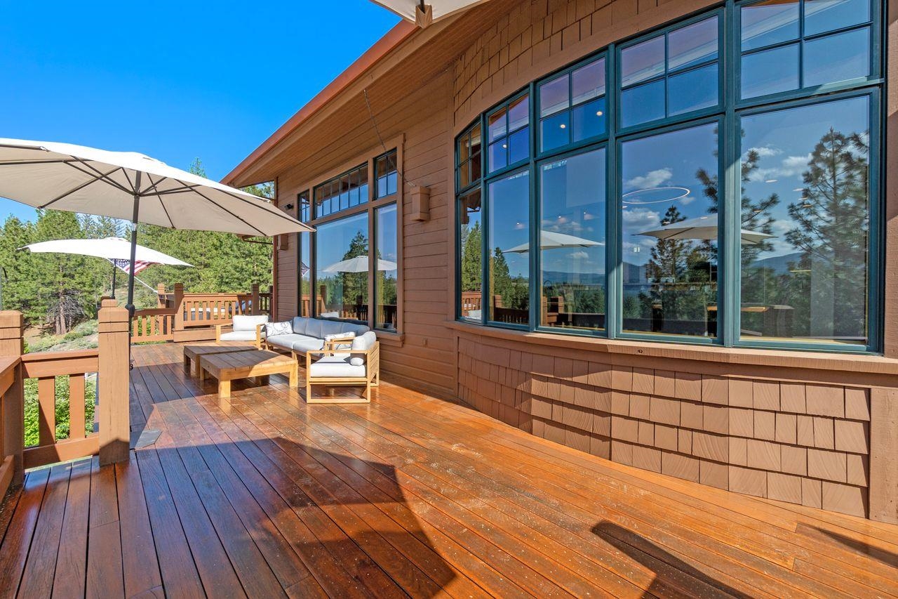 a view of a patio with lawn chairs under an umbrella