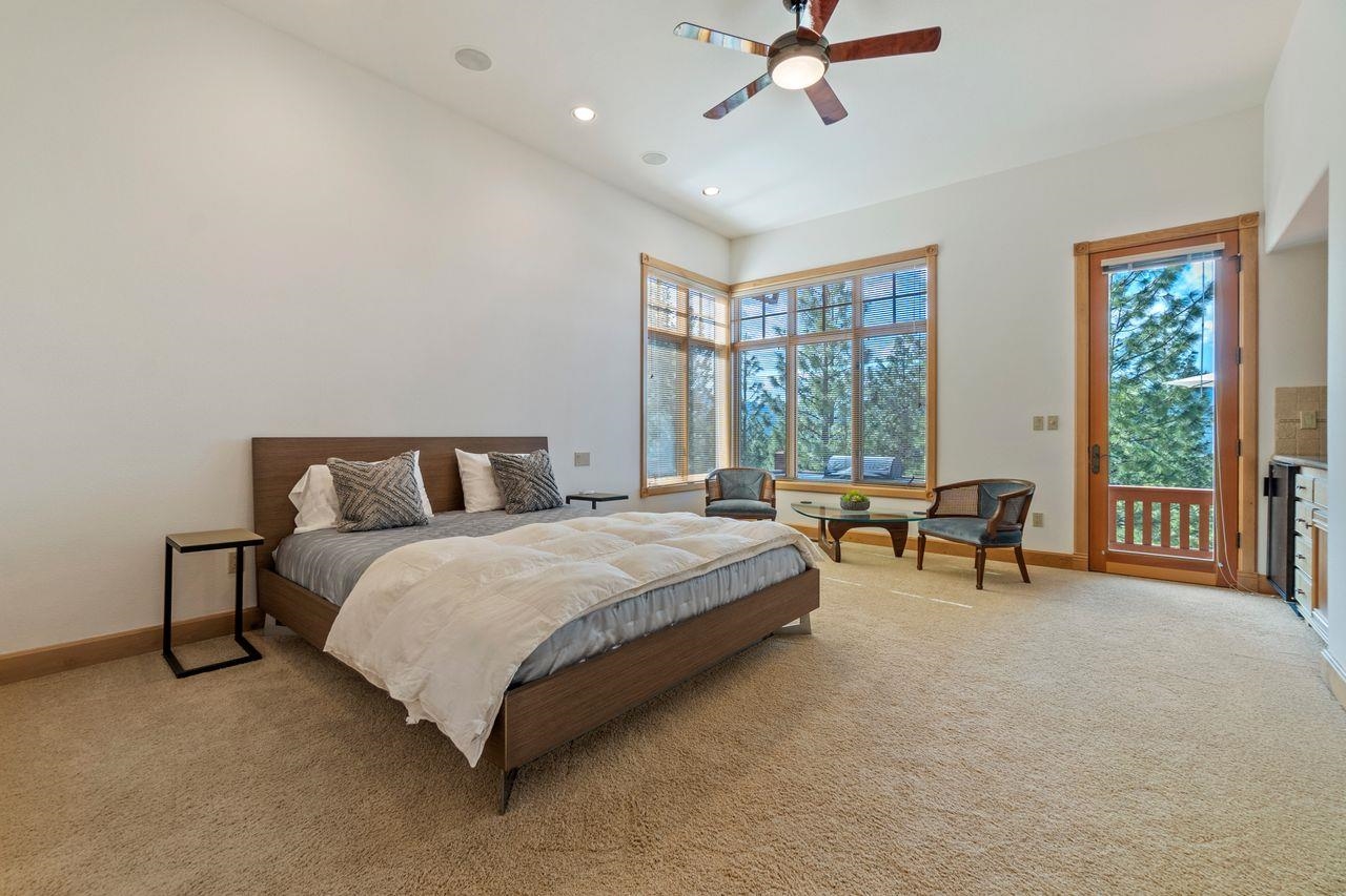759 Red Sky Clio, CA 96106 - Photo 13 of 21 a spacious bedroom with a bed and a chandelier