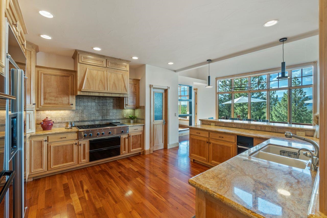 759 Red Sky Clio, CA 96106 - Photo 5 of 21 a kitchen with stainless steel appliances granite countertop a stove a sink and a refrigerator