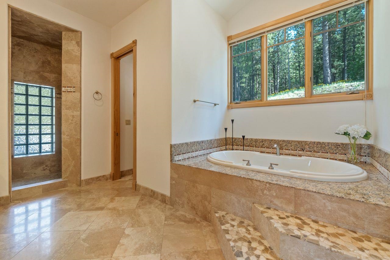 759 Red Sky Clio, CA 96106 - Photo 8 of 21 a bathroom with a tub a window and a shower