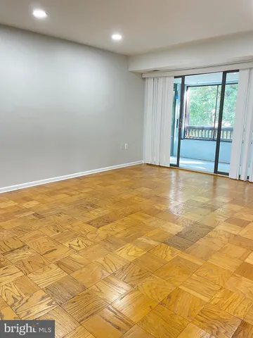 a view of an empty room with glass door
