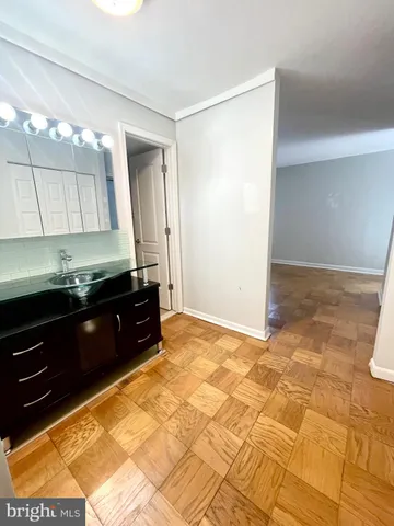 a room with a sink and cabinets